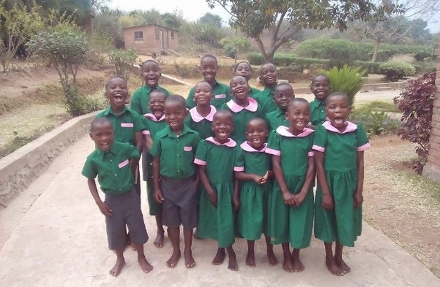 Lucy, Aleka and Junior happy in their new uniforms for Bvumbwe Secondary School 